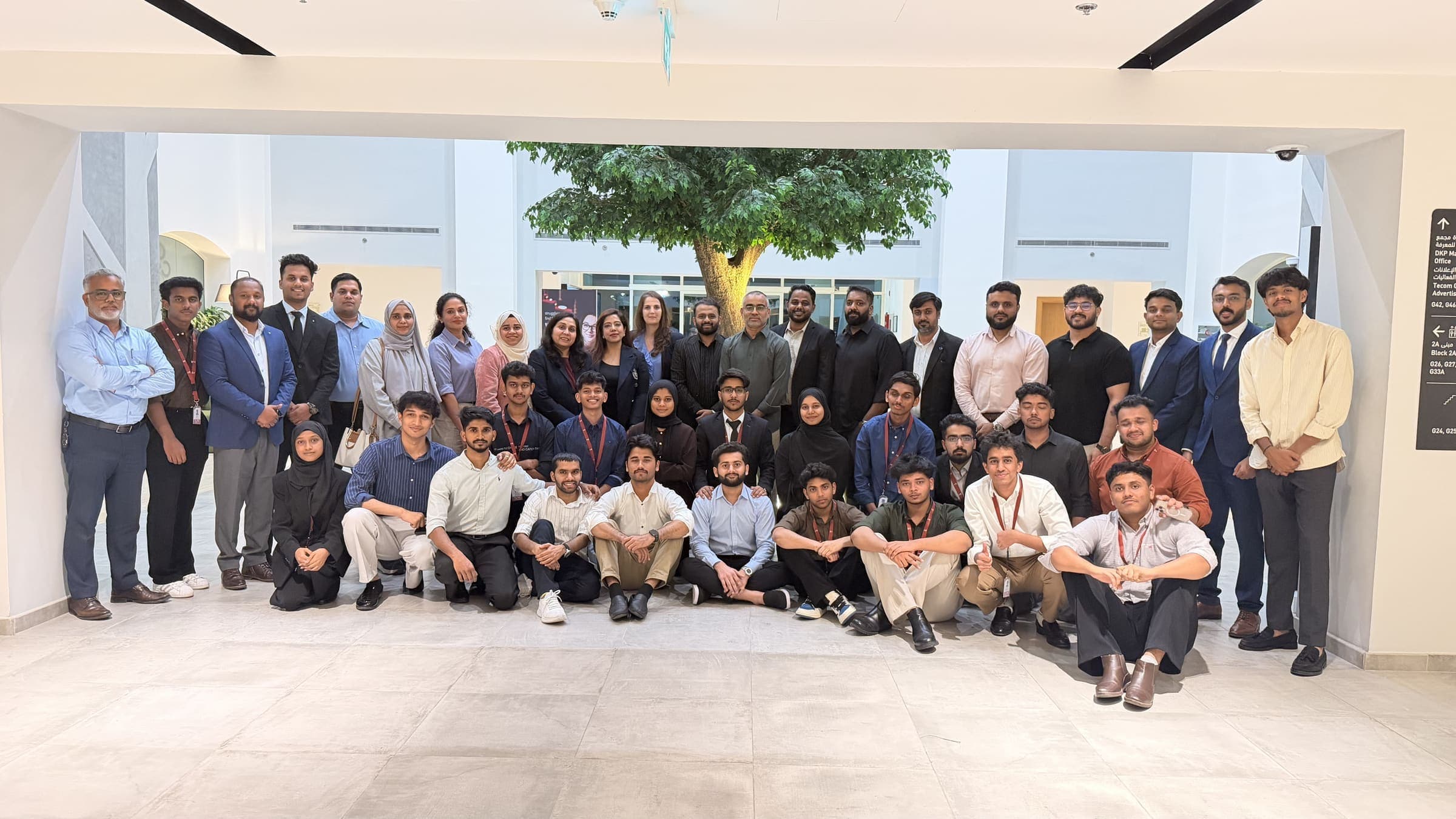 Students and staff photographed together in the Dubai Knowledge Park atrium
